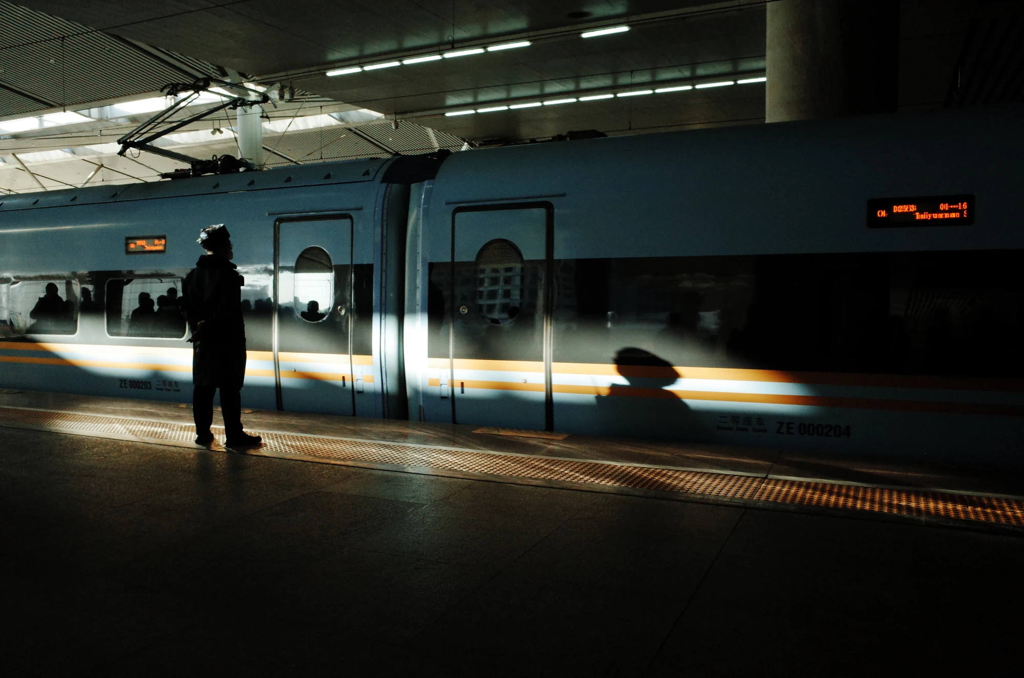 Figures and light on a station platform
